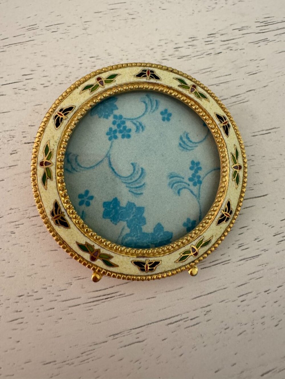 Vintage enamel picture frame with butterfly and floral theme